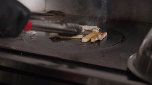 Cooking Meat on Commercial Kitchen Grill