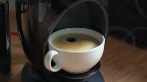 Taking Fresh Brewed Coffee Cup From Machine