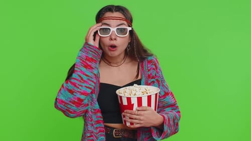 Young Woman Watches a Movie with 3D Glasses