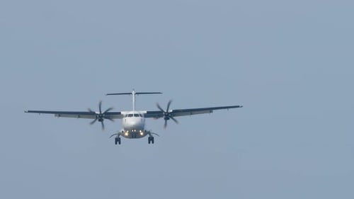 Approaching propeller airplane flying during the day