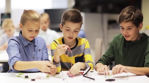 Children Building Robotics Project Together in Classroom