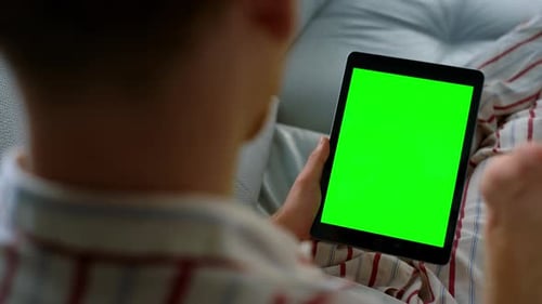 Closeup Hand Scrolling Tablet Making Video Call. Unknown Man Waving Green Screen