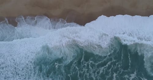 Aerial view of ocean waves meeting the shore, France.