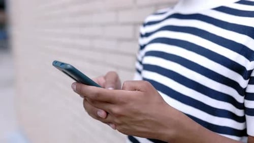 Adult Using Smartphone Outdoors in Daytime