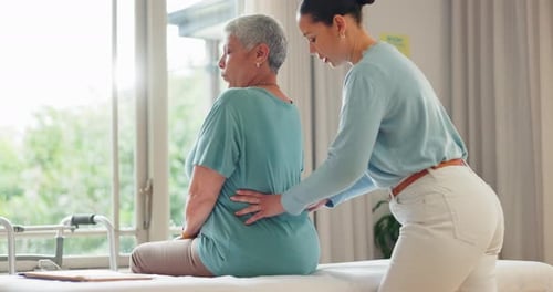 Adult Giving Back Massage to Senior in Bright Room