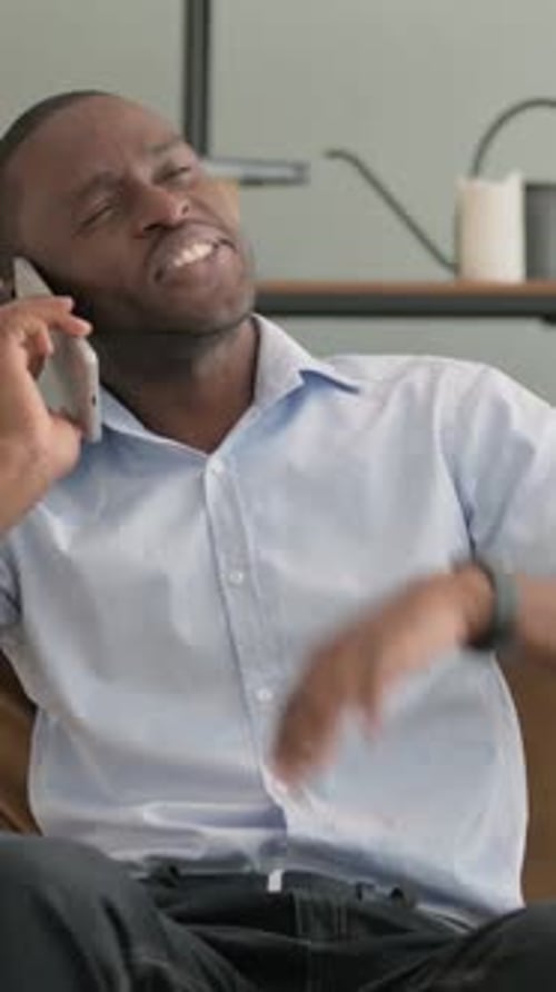 Man Talking on Cell Phone Indoors