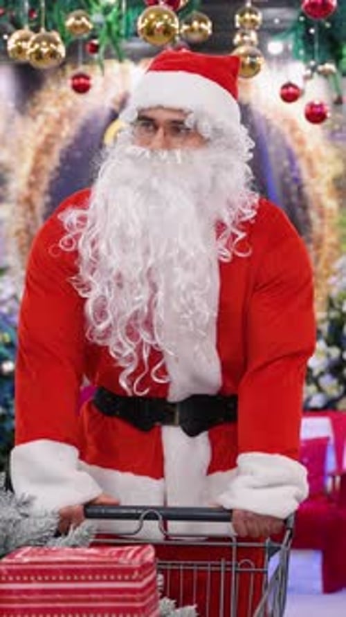 Santa Claus Pushing a Shopping Cart Full of Christmas Presents
