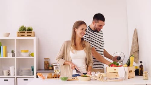Couple Cooking Together in Kitchen Preparing Food