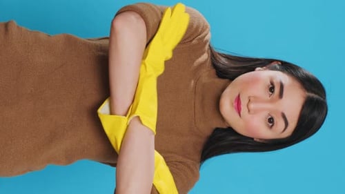 Woman Puts on Yellow Rubber Gloves