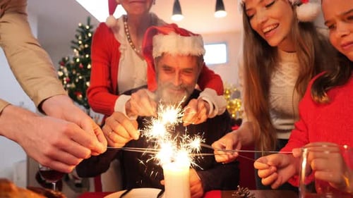 Family Celebrates Christmas with Sparklers at Home