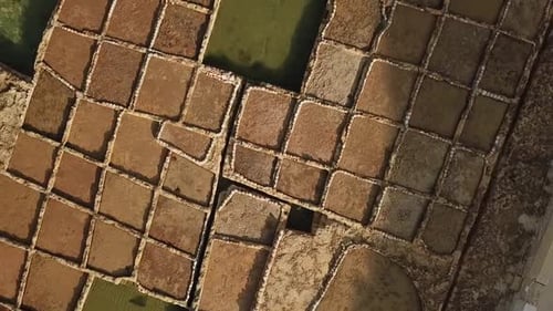 Aerial view of the salt pans at Xwejni bay, Gozo, Malta. Rotating view showing the geometric shapes