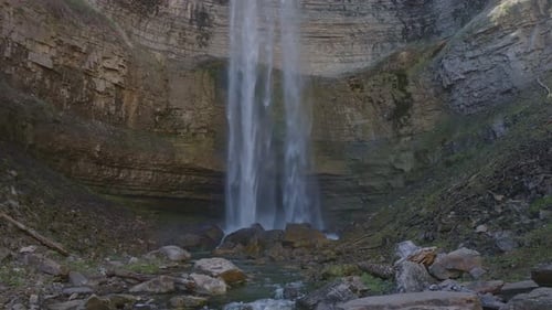 Majestic waterfall cascading into a serene rocky landscape