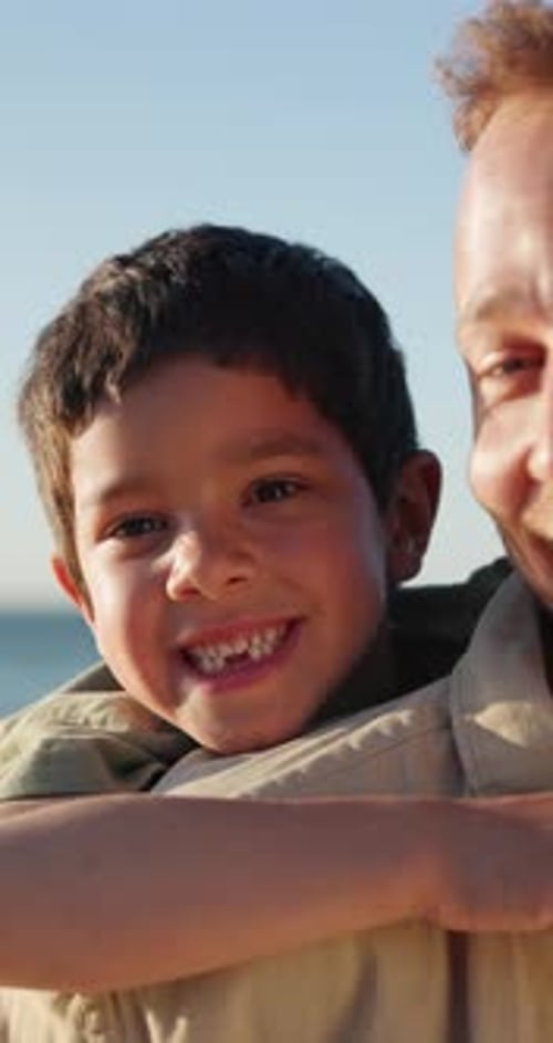 Face, piggyback and kid with father at beach, happy together on holiday or vacation