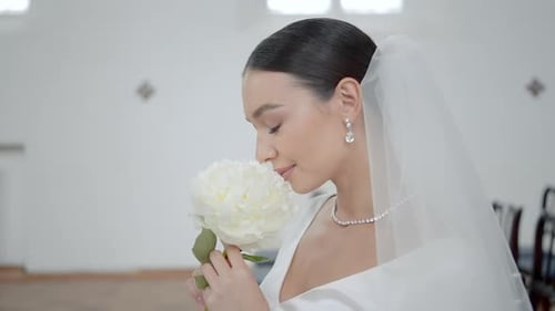 A Wedding Couple in a Church ActionA Young Couple is Sitting on a Decorated Chair in Wedding