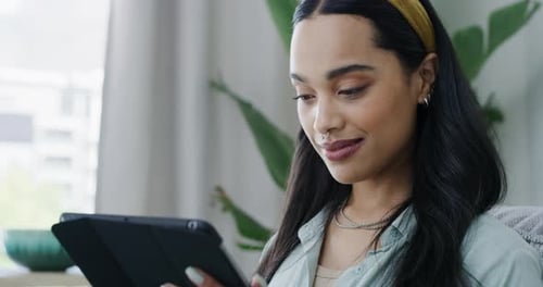 Woman Uses Tablet Relaxing at Home Close Up