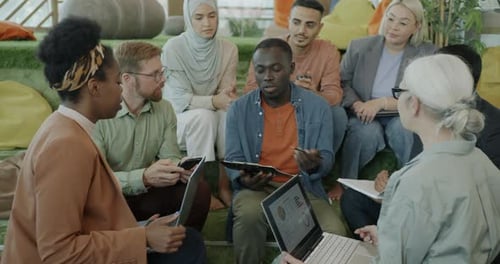 Employees Talking in Coworking Space Brainstorming Enjoying Teamwork in Office