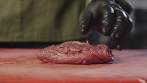 Chef Hands Preparing Raw Red Meat