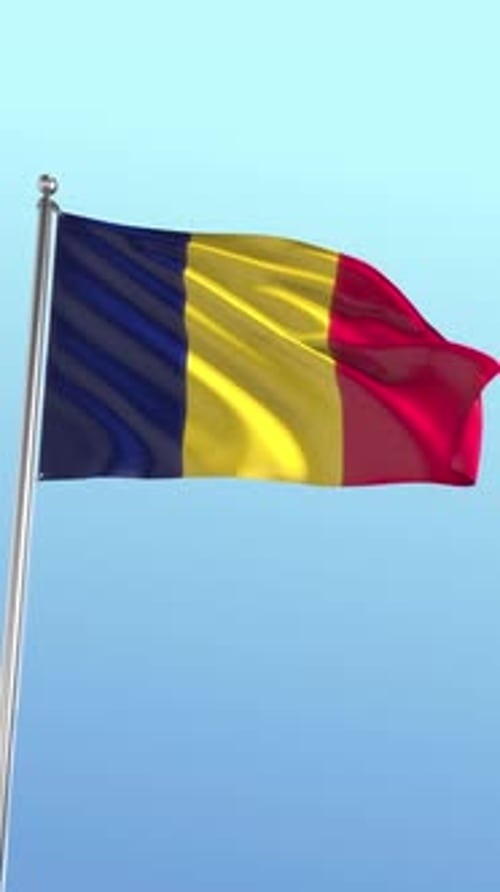 Waving Flag Of Chad Or Romania Against Blue Sky