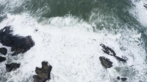 Aerial View Of Ocean Waves Crashing Against Rocks With Water Foam, God's Thumb Oregon Coast