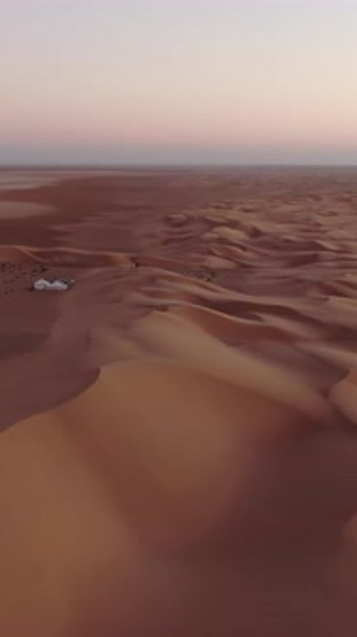Vast aerial view of the Sahara desert landscape during sunset. An epic flight over stunning sand