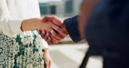 Partner, deal and business people in a city with handshake in support of b2b