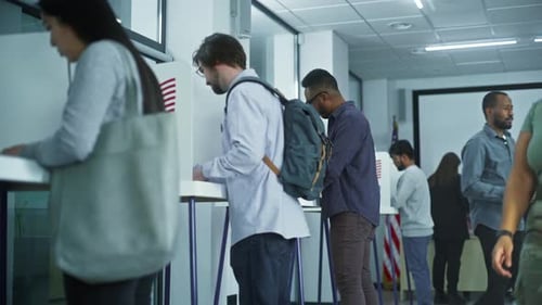 Man in Glasses Comes to Voting Booths in Polling Station Office