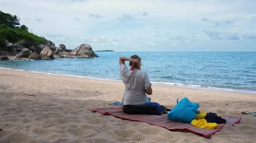 Beautiful Sweet Woman Sits on Sandy Beach