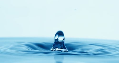 Drop of water falls into a drop of water in a super slow motion. Shot on super slow motion 1600 fps.