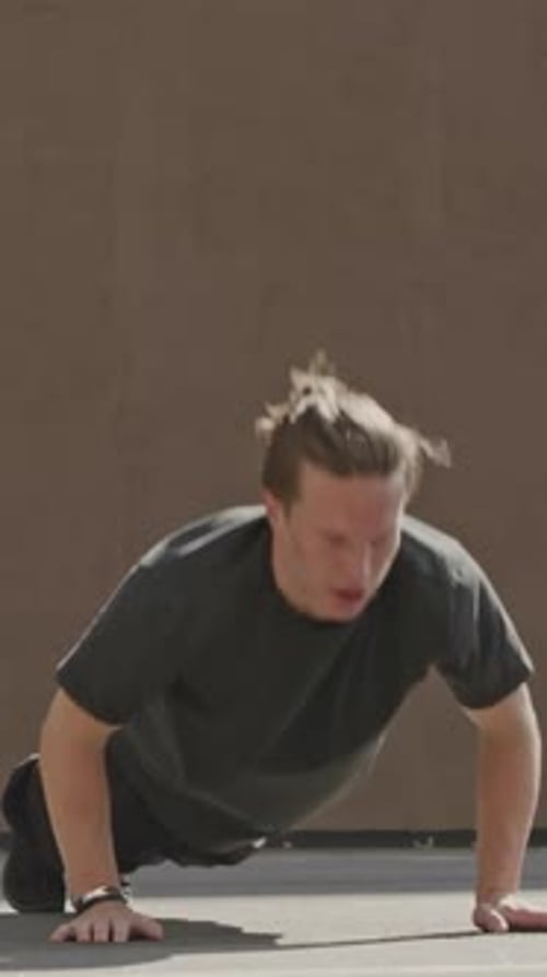 Young Adult Working Out Doing Pushups Outside