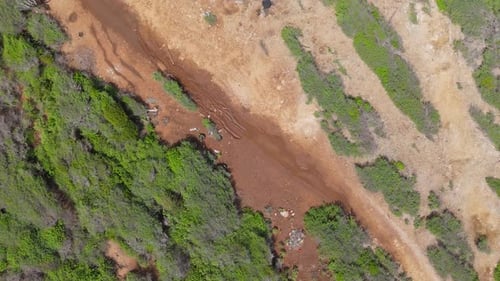 Top down dirt road with rain puddles in Curacao