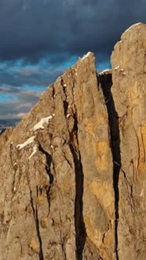 Rocky snow mountains at sunset aerial