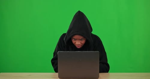 Black woman, green screen or hacker hacking on laptop in cybersecurity, information technology