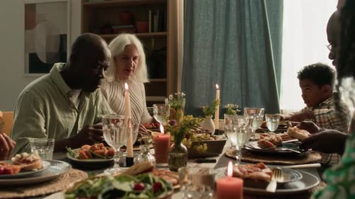 Diverse Group Shares Meal at Candlelit Table