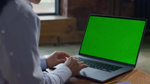 Browsing on Laptop with Green Screen Mockup