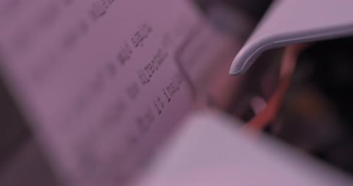 Typewriter close up as lettering keys connect with ink to paper. Captured in 4K.