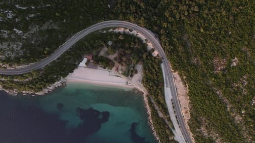 Aerial view of beach, road, blue water at sunset, Croatia.