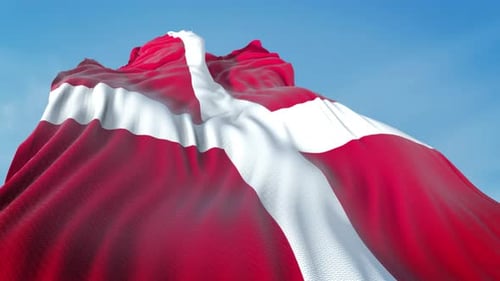 Realistic Waving Flag of Denmark Against a Blue Sky