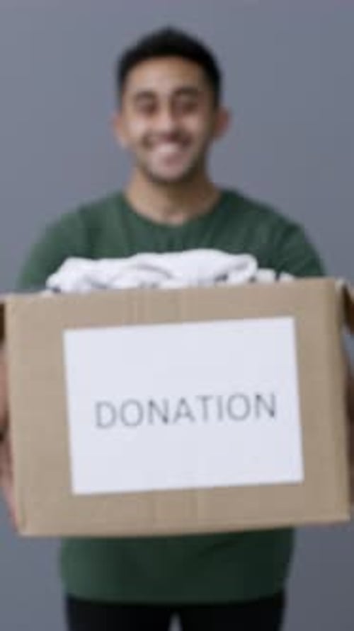 Face, man or clothes in donation box for non profit, community care or giving in studio