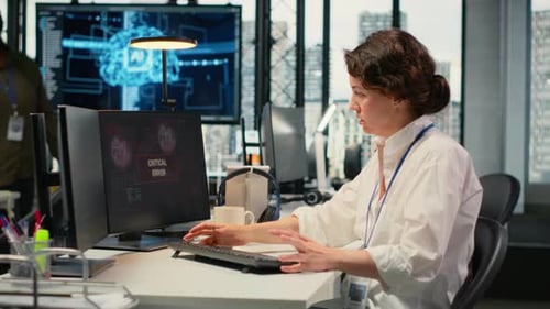 Woman Works at Computer with Critical Error Message