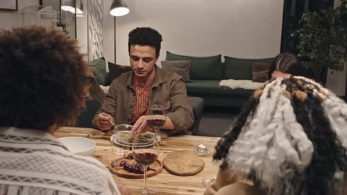 Friends Share Meal and Red Wine at Home