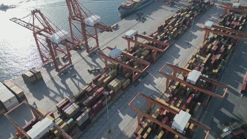 Aerial View of a Port Container Terminal with Cranes Loading a Ship