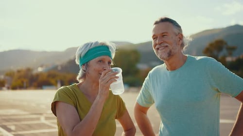 Mature Couple Taking a Break After Exercising Outdoors