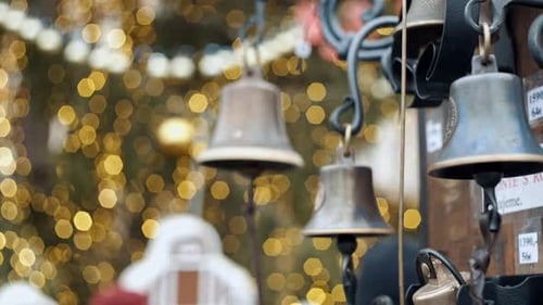 Closeup View of Many Beautiful Old Fashioned Golden Christmas Bells Hanging As New Year