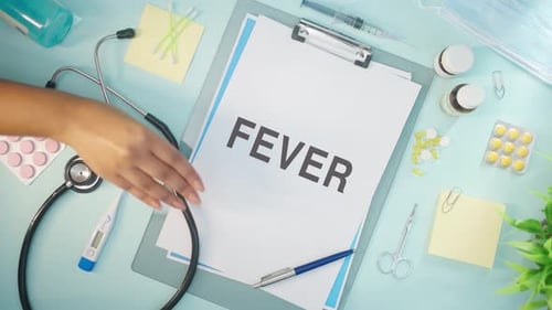 Medical Desktop with Fever Diagnosis and Hand Writing