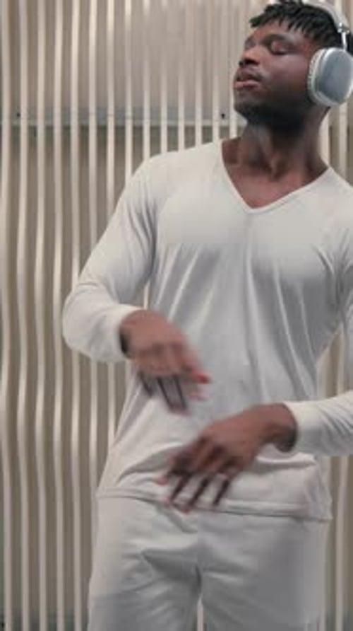 Man Listening to Music and Dancing Indoors