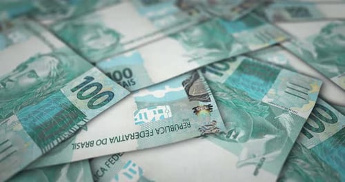 Brazil Real 100 banknote flying over money surface