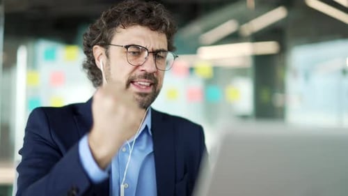 Man Actively Engaged in Online Video Call at Work