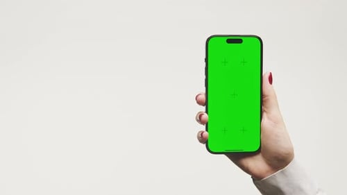Hand Holding Smartphone with Green Screen Isolated on White Background