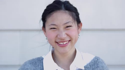 Close Up View of Happy Young Asian Woman Face Smile at Camera Outdoors