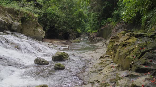 tranquil stream flowing from the Goa Rang Reng waterfall in Bali ...